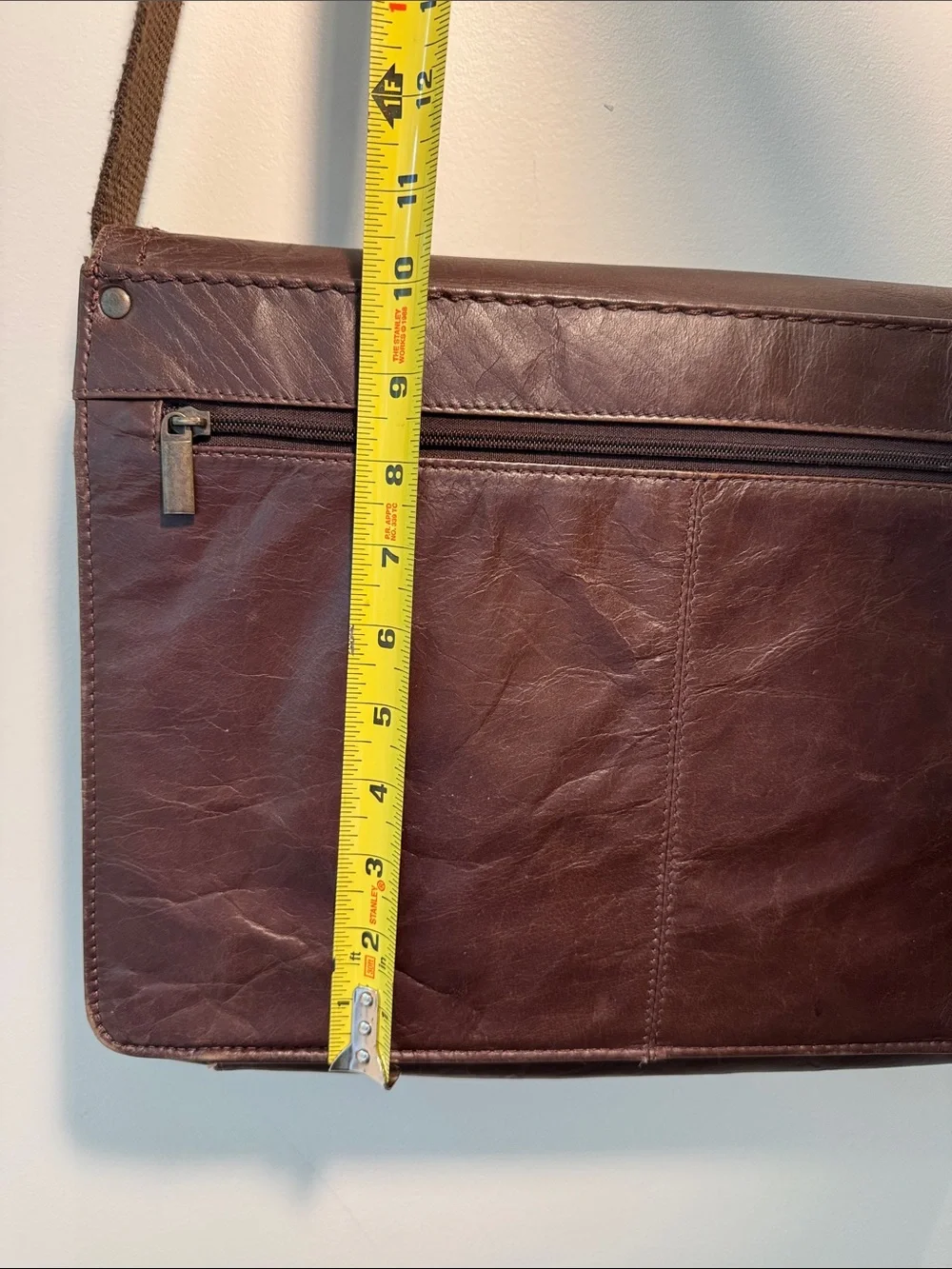 Wilson’s Leather chocolate brown messenger bag with webbed adjustable strap.